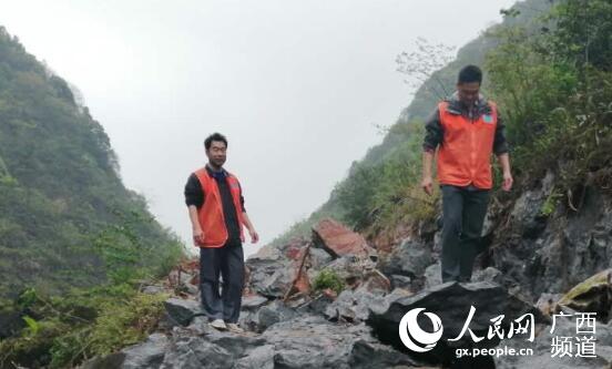 庄寧斌（左一）和隊友查看屯級路建設情況。譚秀輝攝