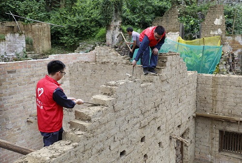 羅城供電局志願者在幫助貧困戶廖顯細拆除舊房。廖光福攝