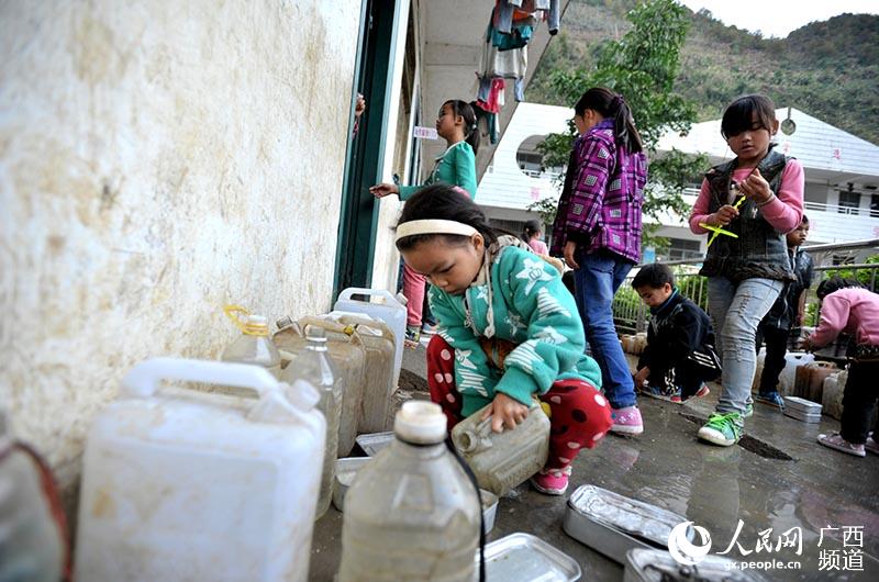 以前，板升鄉八好小學每周定期打開學校水櫃兩次，讓學生用水壺接待水使用。韋哲攝