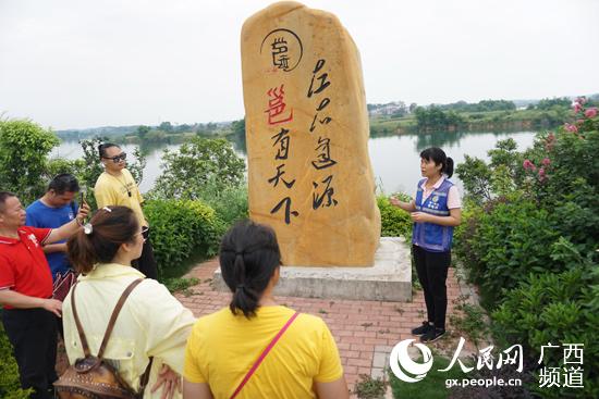 李粵玲在江南區三江坡給游客講邕江源頭故事。尹慶南攝