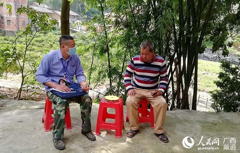 陳橋（左一）正在鼓勵貧困戶就業。蔡果秀攝