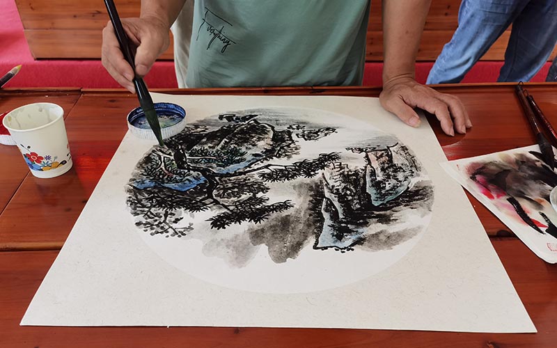 農民畫家手紙筆墨，描繪秀美山河。鄧冠敏攝