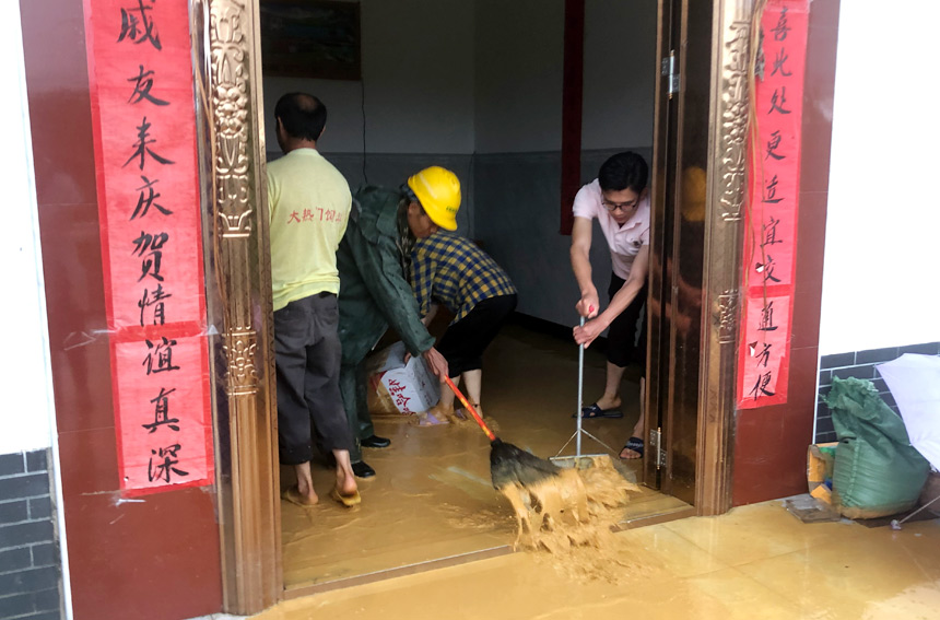 幫助群眾清掃污水。