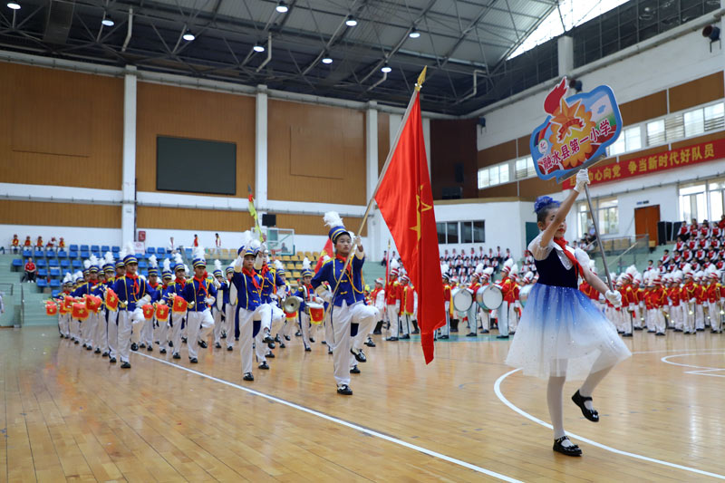 县城学校鼓号队的队员们迈着整齐矫健的步伐，和着清晰有力的鼓点接受检阅。