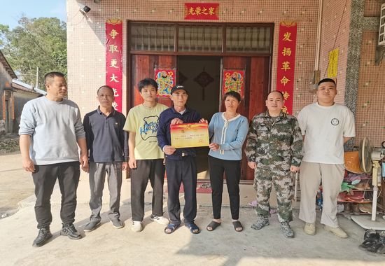 合浦县沙田镇武装部到上新村现役军人付小文家中送立功喜报。