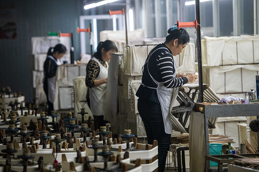 工人在生产车间内认真工作。何华文摄