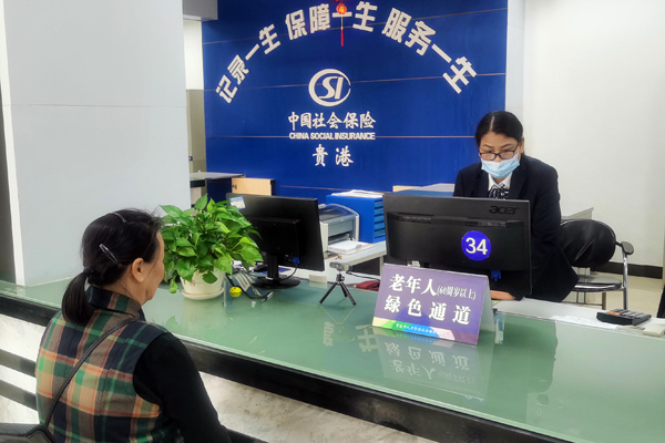 覃菊群为苏秀爱女士办理生存认证的画面
