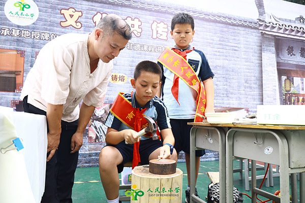 非遺傳承人李師傅現場指導學生打金。南寧市人民路東段小學供圖