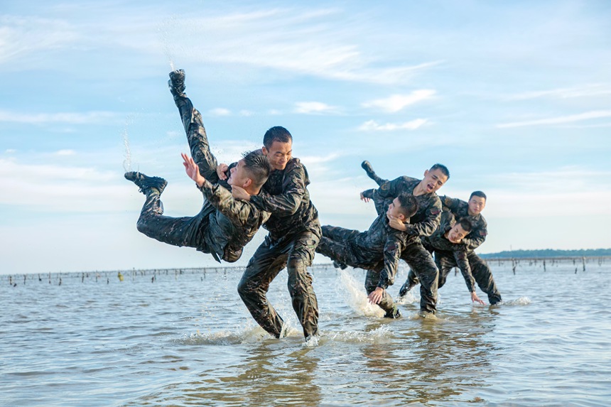 武警官兵在海水中进行擒敌对抗训练。
