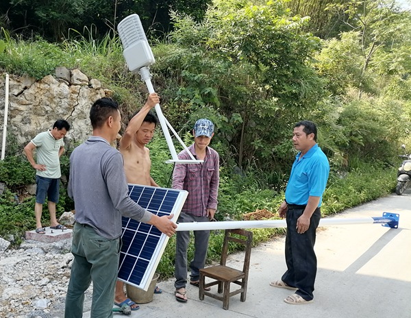 大龙村群众在主干道上安装太阳能路灯。潘璠摄