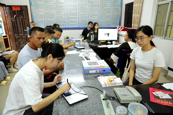 图为学生在父母陪同下办理生源地助学贷款
