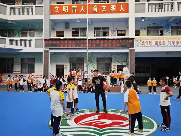 图为文明校区五年级学生进行篮球赛的画面