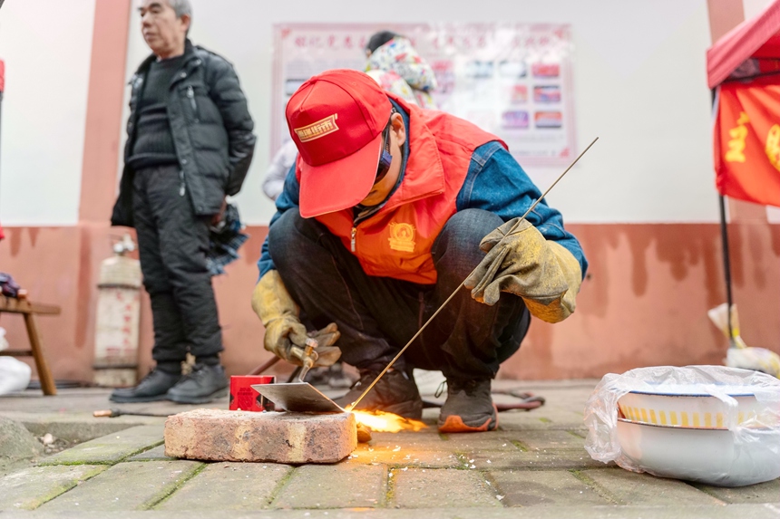 志願者為群眾焊接刀具。蘭炳侶攝