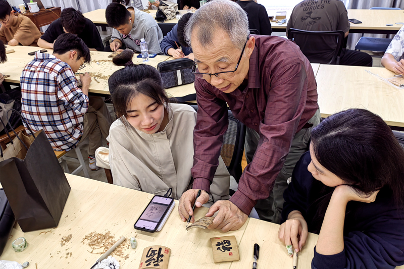 给学生传授多年积累的雕刻技法。
