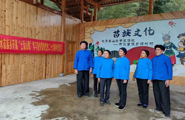 桂林市非物质文化遗产（苗族山歌）传承人康奇龙（右一）在烟竹民族广场用山歌宣传党的二十大精神