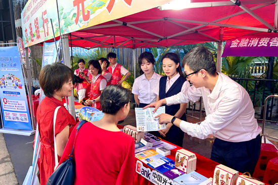 青年志愿者们向社区居民介绍养老金融宣传折页。光大银行南宁分行供图