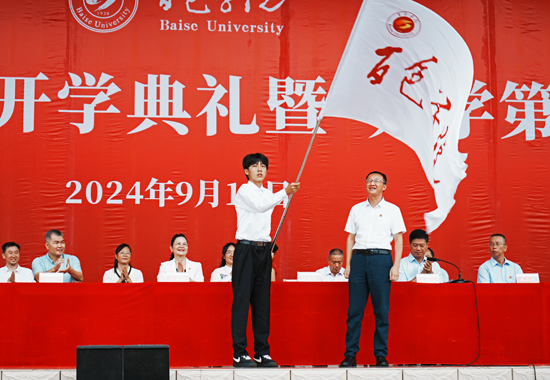 百色学院校长吕嵩崧向新生代表授校旗。邓民胜摄