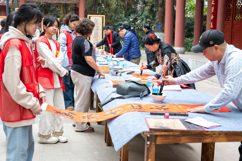 当地美术家和书法家们携手为市民群众义写春联送祝福，喜迎新年到来。何华文摄