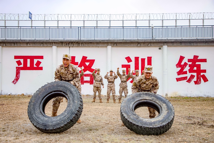 武警官兵在進行翻滾輪胎訓練。