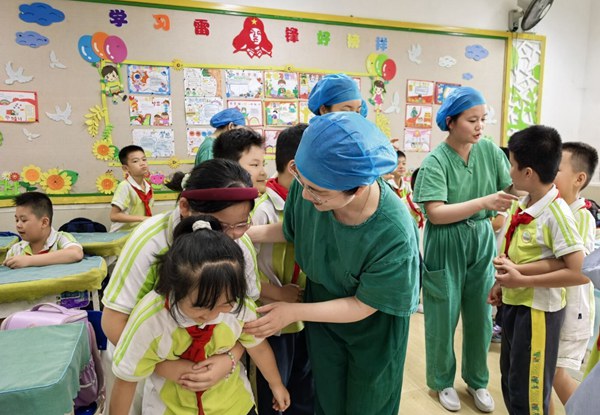 图为学生练习急救技能现场。河池市人民医院供图