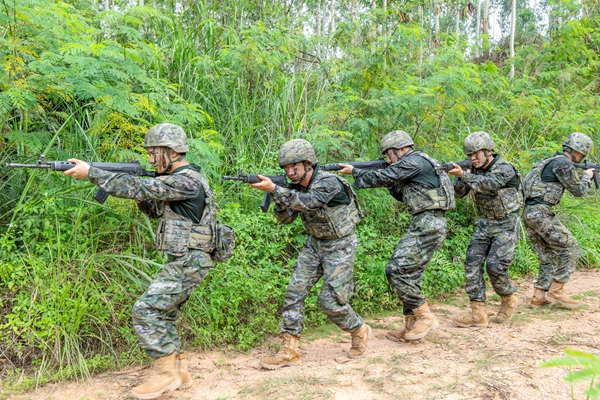 武警官兵在进行班组搜索。
