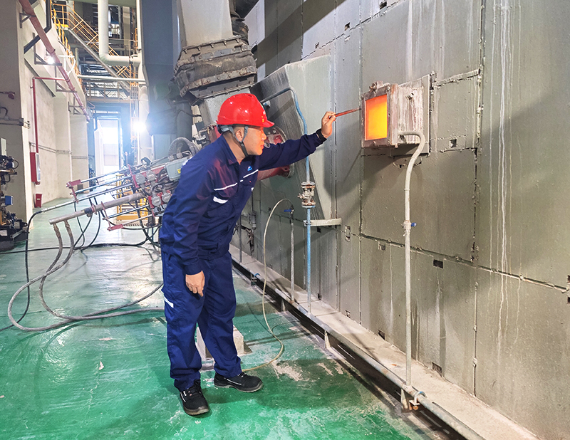 邱建勋在车间内查看锅炉燃烧工况。曾韫坤摄