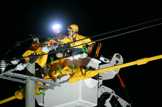 10月1日晚，南方電網廣西新電力集團田林供電公司搶修人員對受損的10千伏百陸線進行帶電作業接線。班祖昌攝