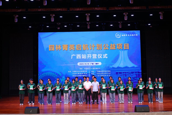 与会领导为学员颁发“成长手册”。周山荃摄