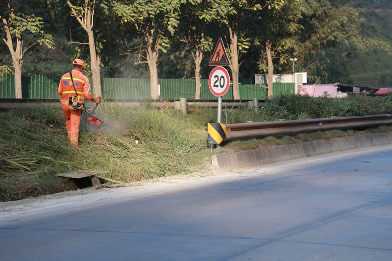 藤縣公路養護中心對國道321線西江機場附近路段進行路容整治工作。黎陽艷攝