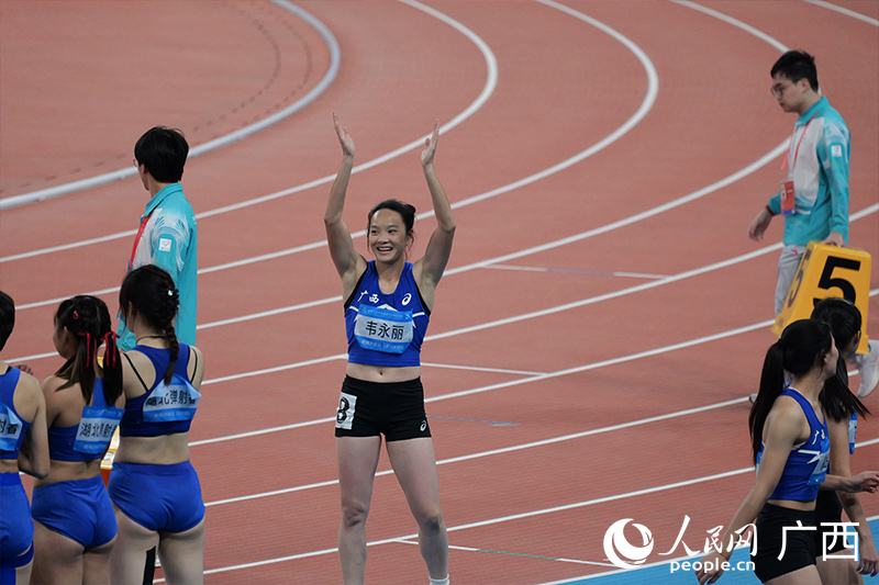 韦永丽冲线后与观众互动。人民网 梁章晖摄