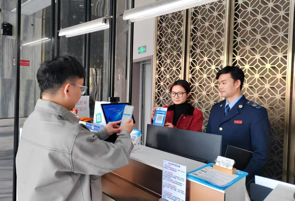 顾客在永福县鑫亚垛酒店使用“支付即开票”功能。蒙玉秀摄