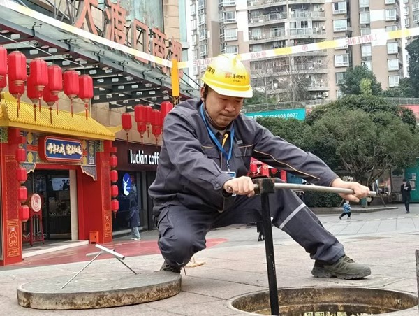 Gas worker checking valve in underground network