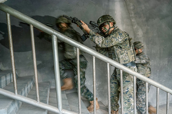 官兵掩护队友追击目标。何其骏摄