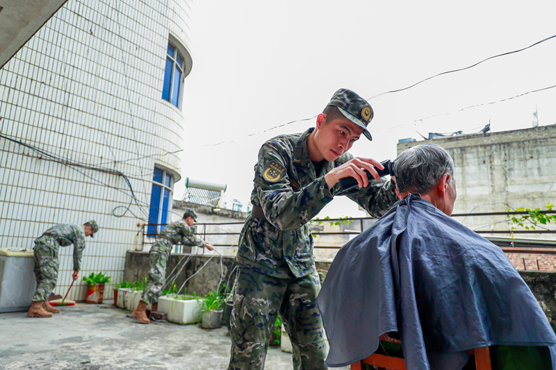 官兵为老兵理发。许校旗摄
