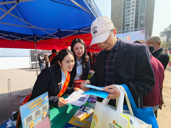 图为农银人寿桂林中支党支部党员为群众讲解金融知识。蒋伶俐摄