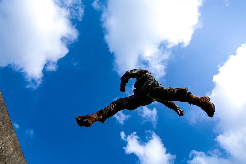 參訓官兵跨越壕溝。代禮意攝