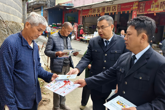 工作人员向群众发放普法资料。莫雅钧摄