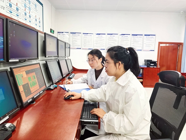 图为莫燕萍（图右）在指导工区职工进行数据配置。李福至摄.jpg