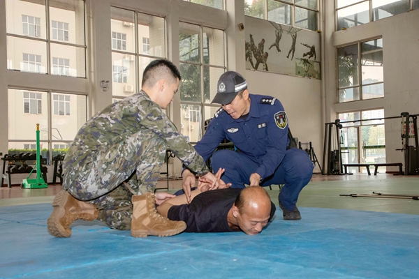 武警官兵正在训练现场控制与带离动作。