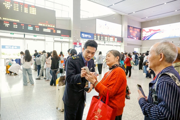 桂林车站客运工作人员解答旅客问询。郑长贤摄