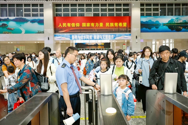 桂林车站客运职工维护检票秩序。郑长贤摄