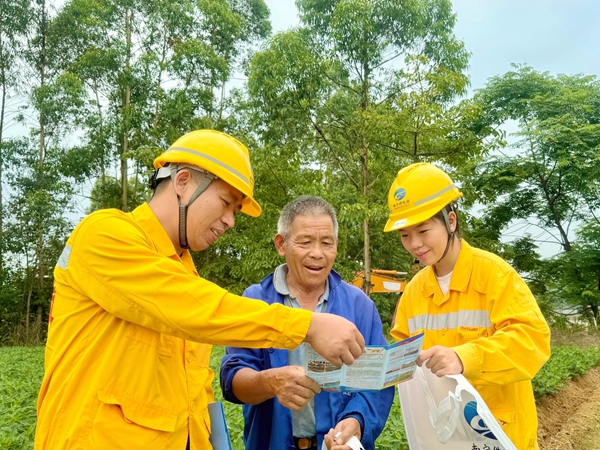 南寧供電段職工正在為沿線居民科普愛路護路知識。陳雅菲攝