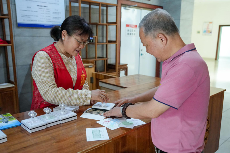 5月18日，在梧州市博物馆，游客在志愿者的指导下盖印梧州特色文创印章。李灿明摄