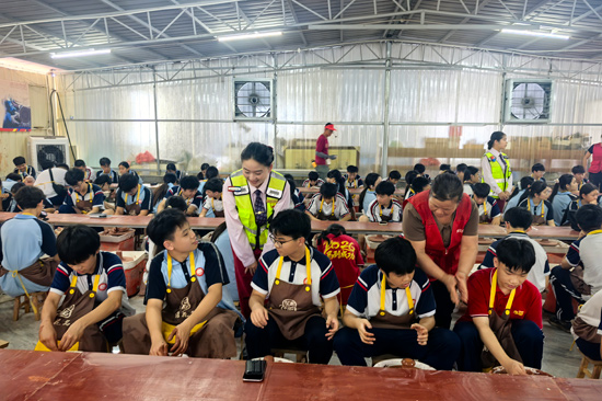 广西交通投资集团钦州高速运营有限公司六钦分公司志愿者与学生共同体验制作泥兴陶。覃雪英摄