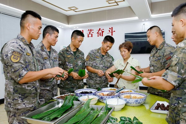 官兵和駐地家屬一起包粽子。劉俊暉攝