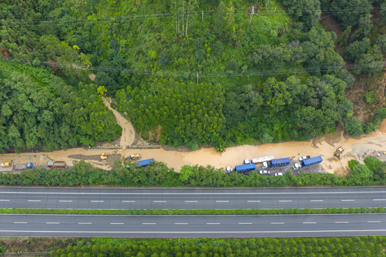 航拍视角下三台机械正在进行道路清淤。 杨啟建 摄