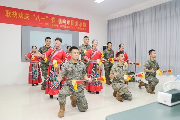 武警官兵與瑤族兵媽媽合演長鼓舞《我們共同的家園》。