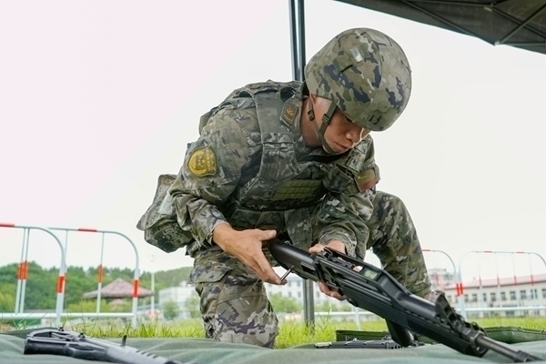 武警官兵进行轻武器换件维修。