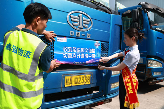 司机们主动参与，协助工作人员将消保风险提示海报固定在车厢上，化身金融知识“流动宣传员”。浦发银行南宁分行供图