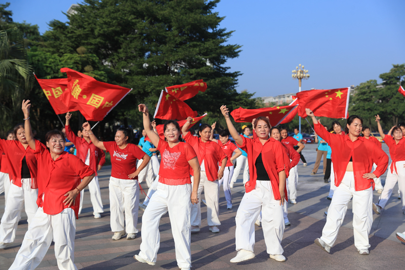 群众跳广场舞欢迎冠军凯旋。